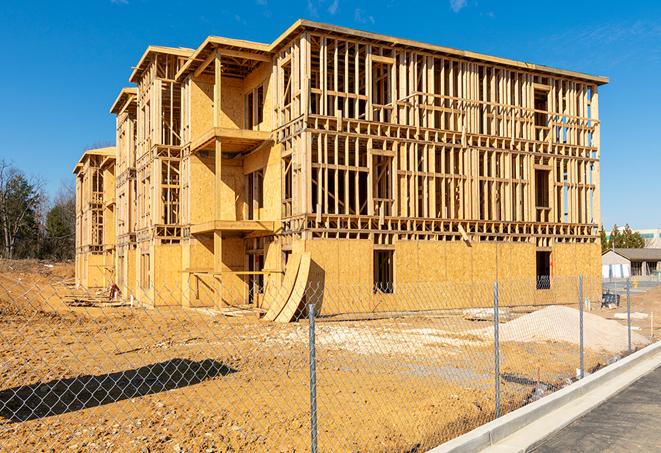 a construction site enclosed by temporary chain link fences, ensuring safety for workers and pedestrians in Round Lake Heights, IL